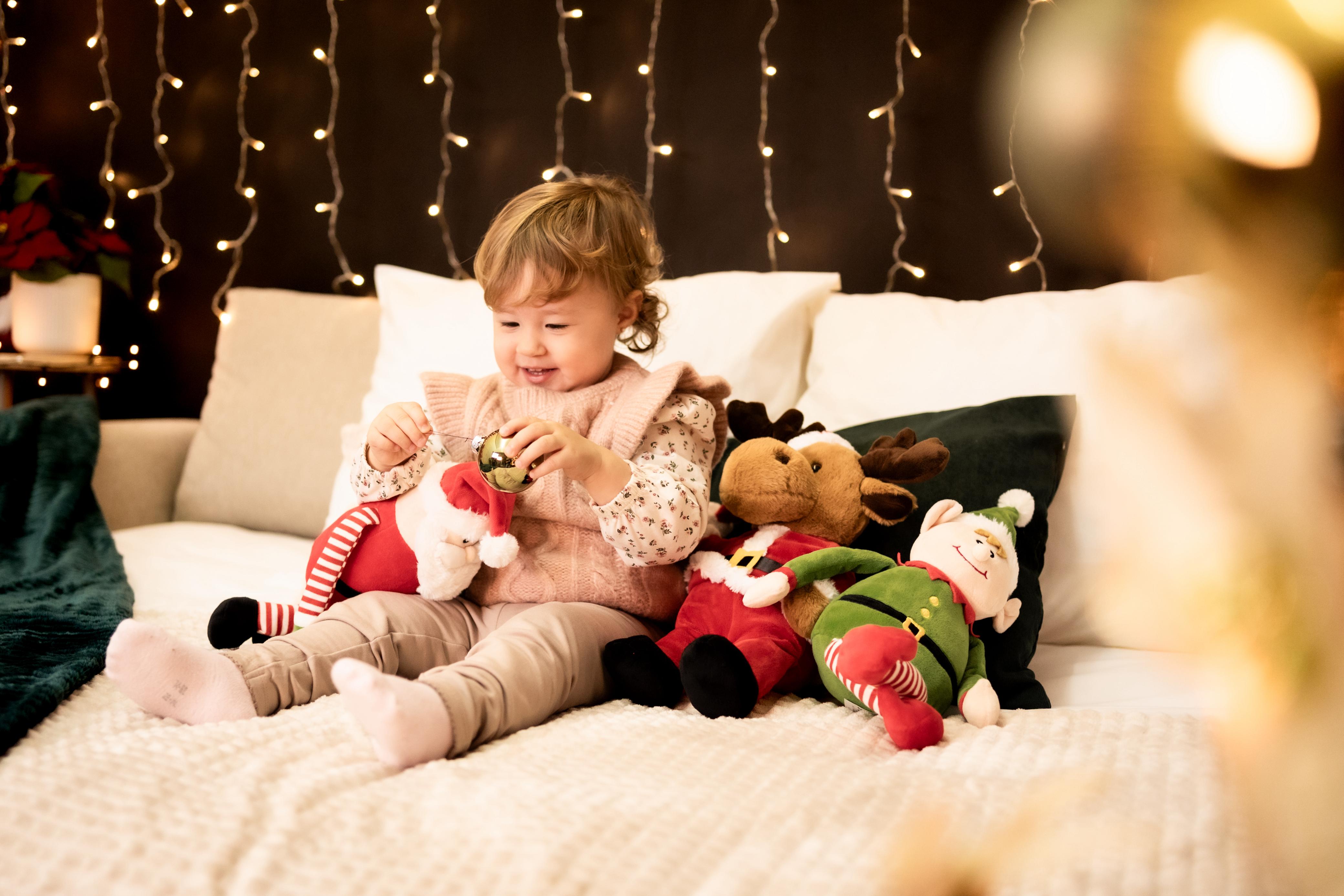 Adorable child admiring decorated tree.